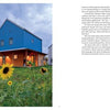 A charming blue two-story home with a wooden porch sits amid yellow blooms in a grassy yard, highlighting thoughtful design. The cloudy dusk sky sets the mood. "Design with Love" by Schiffer Publishing, Ltd. is shown on the right.