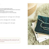 A quilted dark green tablet case with a flap and light trim rests on a white surface beside coffee, a notebook, and a small woven basket. On the left, "Little Delights in Leather" by Schiffer Publishing, Ltd. lies open to sewing instructions.