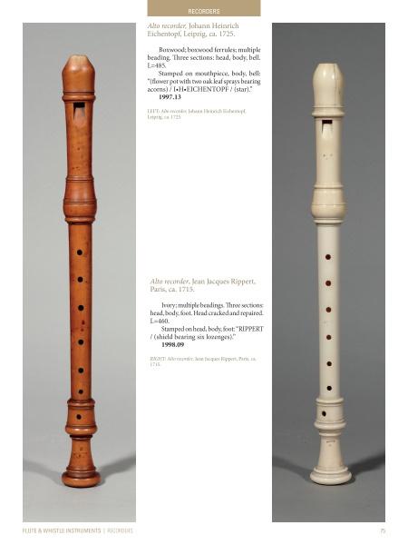 Two rare baroque recorders, one light brown and one white, stand upright side by side in "Four Centuries of Musical Instruments" by Schiffer Publishing, Ltd. Both feature finger holes, decorative rings, and detailed maker information above and below.