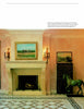 A grand stone Schiffer Publishing, Ltd. Fireplace with a painting above and wall sconces on each side, set in a salmon-walled room with patterned tile floor, decorative folding screen, and a life-sized horse sculpture.