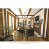 A bright living room from Old Places, New Spaces by Schiffer Publishing, Ltd. features wooden beams, glass doors, a fireplace, and framed décor on the mantel, evoking the charm of San Antonio’s historic homes as sunlight streams in.