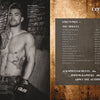 A shirtless male MMA fighter in UFC gloves leans against a brick wall, displaying tattoos. Next to him sits "Ink ’N Guys" by Schiffer Publishing, Ltd., its table of contents listing models, foreword, and photographers—ideal for fans of tattoo photography.