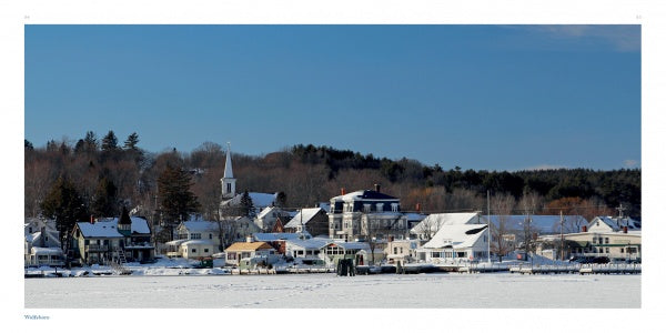 New Hampshire" by Schiffer Publishing, Ltd. showcases a snowy lakeside village with houses, a church steeple, and frosted trees under clear skies—a stunning scenic landscape perfect for photography lovers. The lake is frozen and rooftops are blanketed in snow.