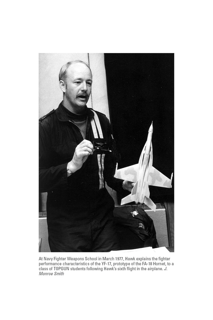 In March 1977, at Navy Fighter Weapons School, an instructor discusses the YF-17 prototype and carrier aviation—scenes detailed in "Black Lion One" from Schiffer Publishing, Ltd.—while holding a scale fighter jet model.