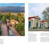 Featured in *Train Stations of the World* by Schiffer Publishing, Ltd., a scenic Greek town appears with mountain views, trees, and buildings; opposite, a yellow-red train is parked at a charming station amid people and a large tree.