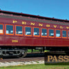 A maroon Pennsylvania Railroad passenger car #3556 sits on display under a blue sky at the Railroad Museum of Pennsylvania, featured in "The Railroad Museum of Pennsylvania in Pictures" by Schiffer Publishing, Ltd.