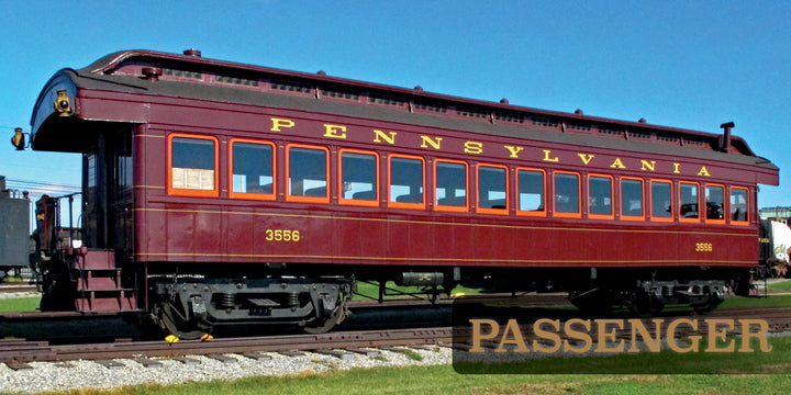 A maroon Pennsylvania Railroad passenger car #3556 sits on display under a blue sky at the Railroad Museum of Pennsylvania, featured in "The Railroad Museum of Pennsylvania in Pictures" by Schiffer Publishing, Ltd.