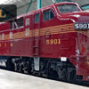 A photo from "The Railroad Museum of Pennsylvania in Pictures" by Schiffer Publishing, Ltd. shows maroon Pennsylvania Railroad diesel locomotive 5901 indoors, with DIESEL at top left and white-gold side detailing against large background windows.